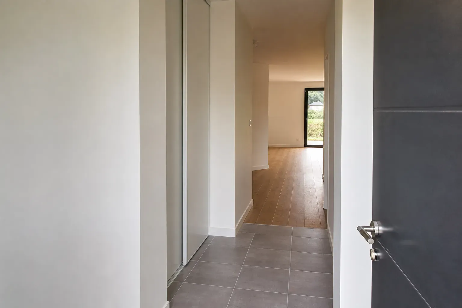 Entrée et couloir d’une maison neuve prête à emménager, sol posé